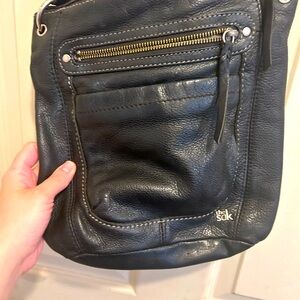 The Sak Grey Leather Crossbody Bag with Textured Finish and Metallic Accents